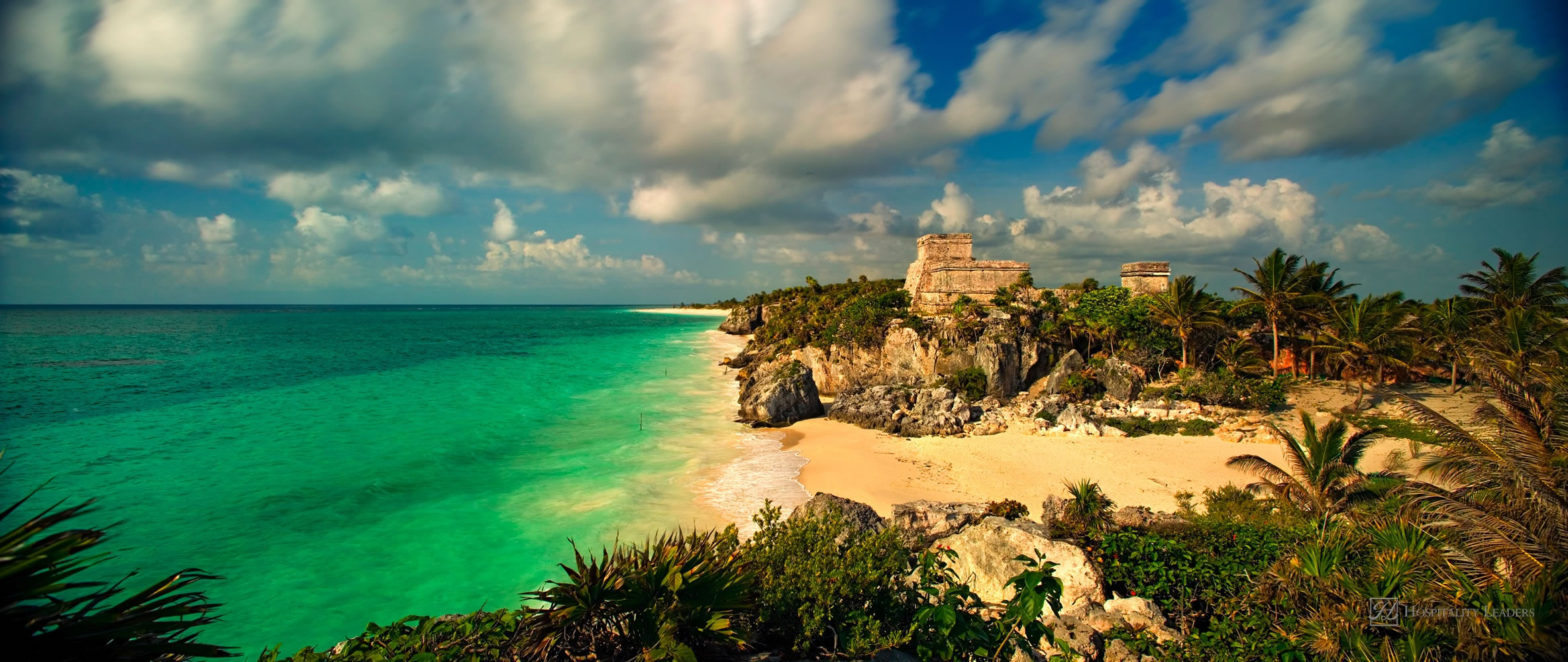 A 110-degree panoramic image of the main temple structure and Gulf of Mexico in the ancient Mayan city at Tulum, Mexico