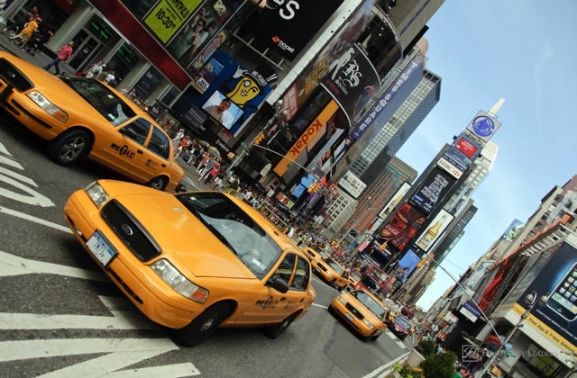 NEW YORK - AUGUST 28: Yellow taxi cabs rush tourists around Times Square on August 28, 2009 in New York City, NY