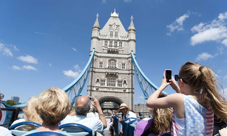 Tourists photograph Tower Bridge