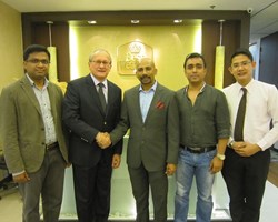 Glenn De Souza (second from left) and Shawkat Hossain (middle) with Maple Leaf Hotels and Resorts, celebrate the deal.