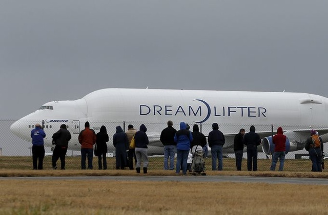 People watch a Boeing 747 Dreamlifter cargo aircraft on a runway at Col. James Jabara Airport in Wichita. Charlie Riedel, AP